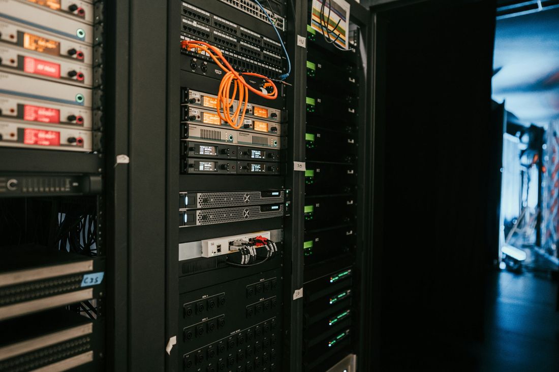 Server rack with patch cabling, networking equipment and an orange fibre lead
