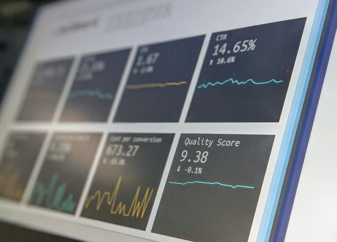Wall of dashboard panels with metrics and trend lines, representing monitoring and vulnerability reporting